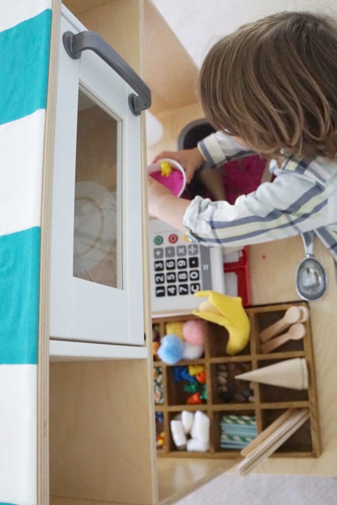IKEA kitchen ice cream shop hack 4 IKEA duktig mini-kitchen ice cream shop, cafe striped awning, lemonade stand, bodega, farmer's market, food stand hack makeover tutorial DIY, chalkboard paint, dramatic play pretend