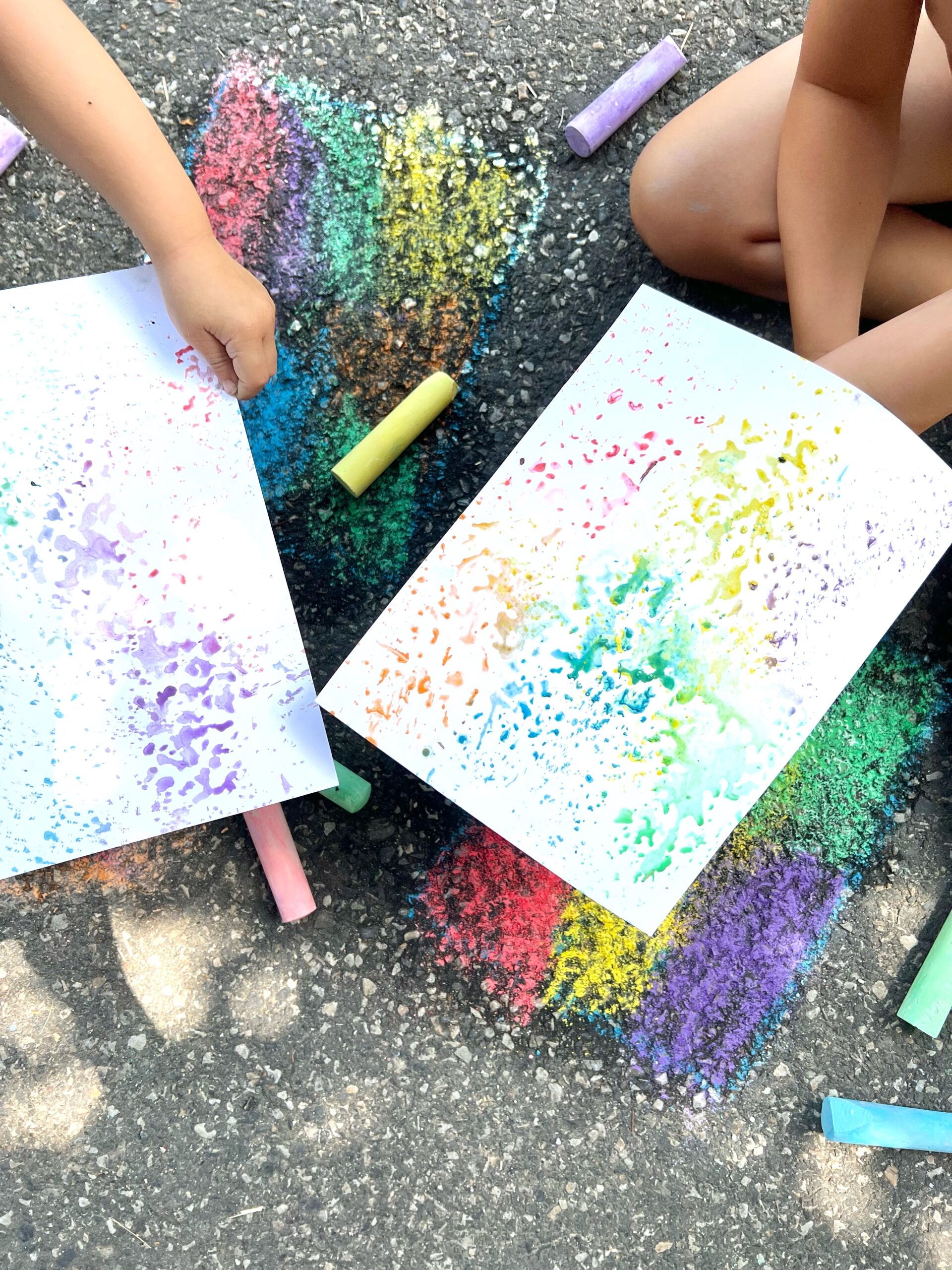 Kids Printmaking with Sidewalk Chalk. Holding colorful Monoprints on paper complete guide to process art for preschoolers